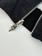 Black hoodie close-up of silver zipper pull and seam