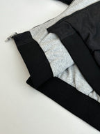 Black hoodie hem with ribbed cuffs and gray inner lining