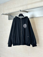 Black zip-up hoodie with hood and small chest emblem, ribbed black cuffs