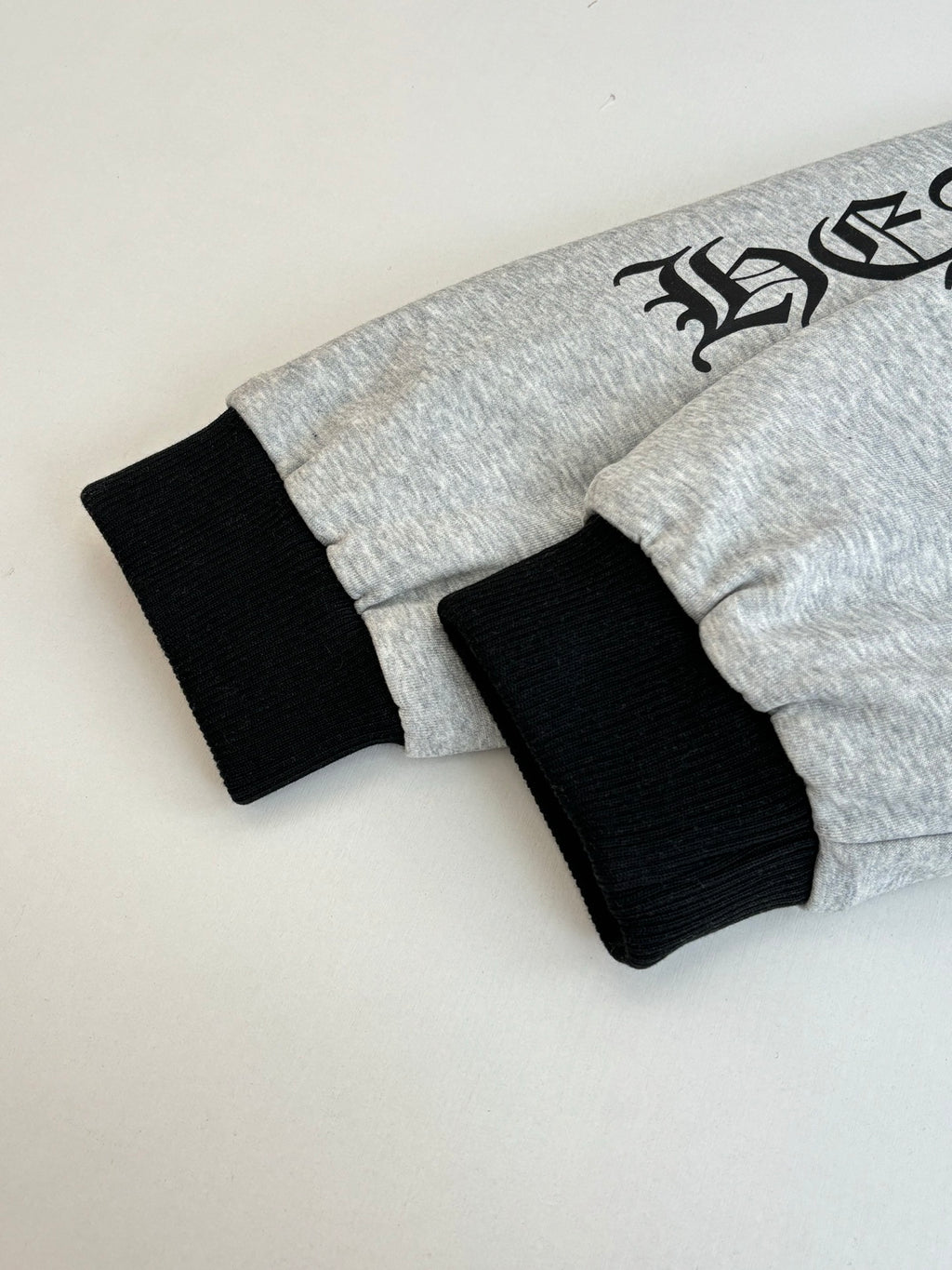Gray hoodie with black ribbed cuffs and hem