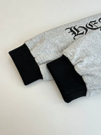 Gray hoodie with black ribbed cuffs and hem