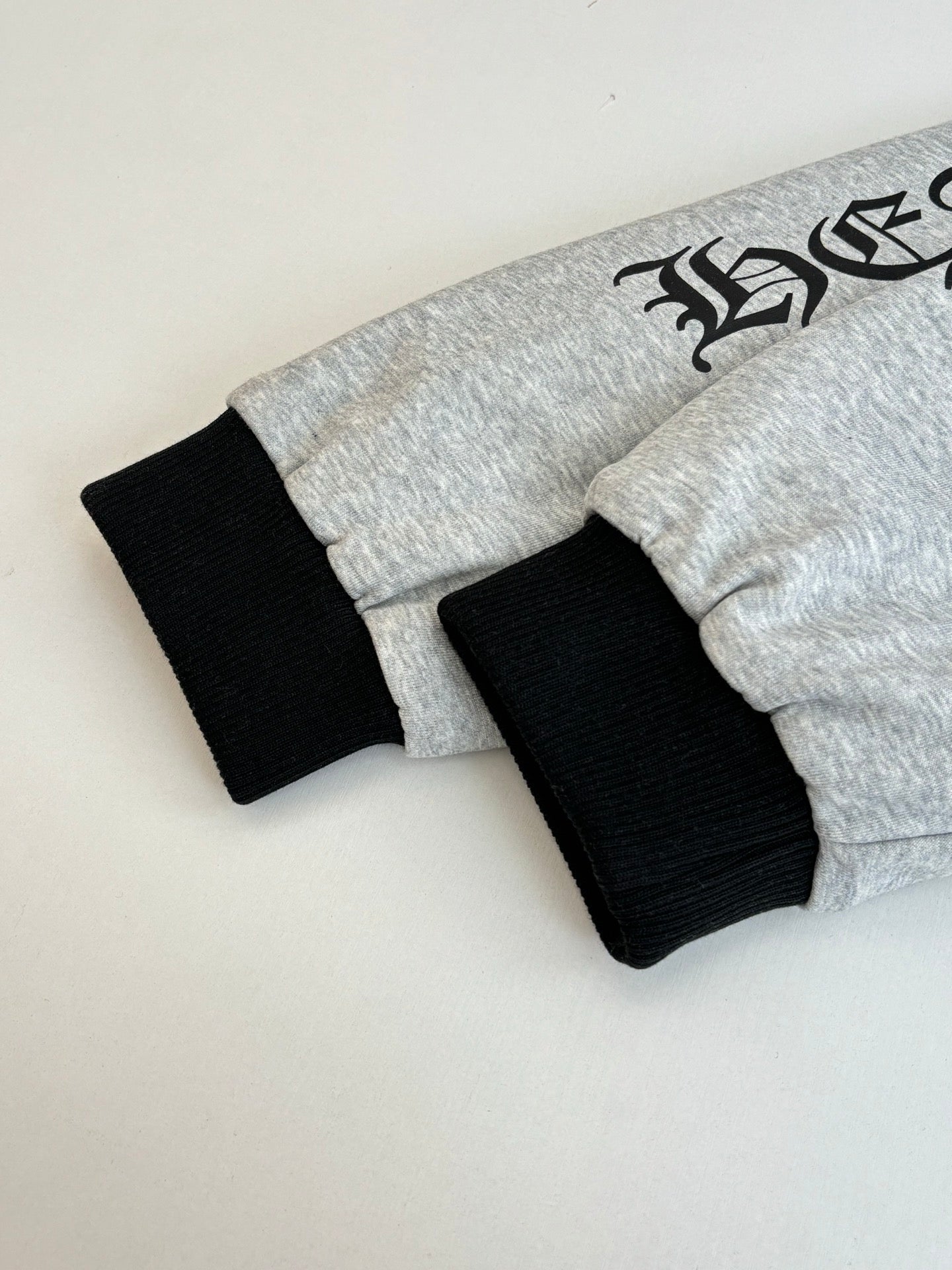 Gray hoodie with black ribbed cuffs and hem