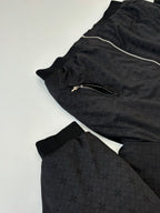 Black zip-up hoodie laid flat with hood, visible zipper, and textured pattern
