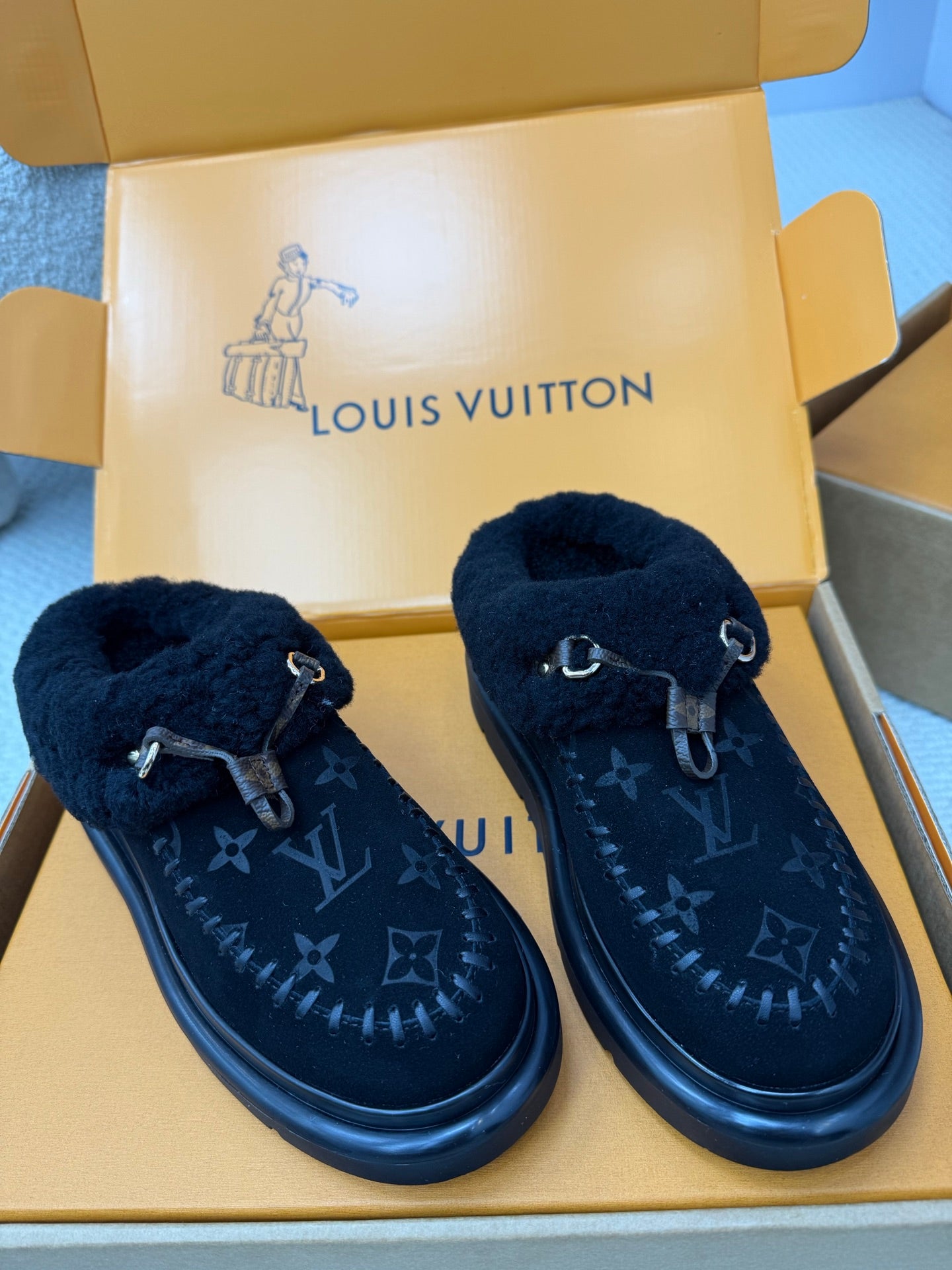 Ladies slip-on shoes, plush cuff, dark monogram pattern, buckle strap, low profile sole