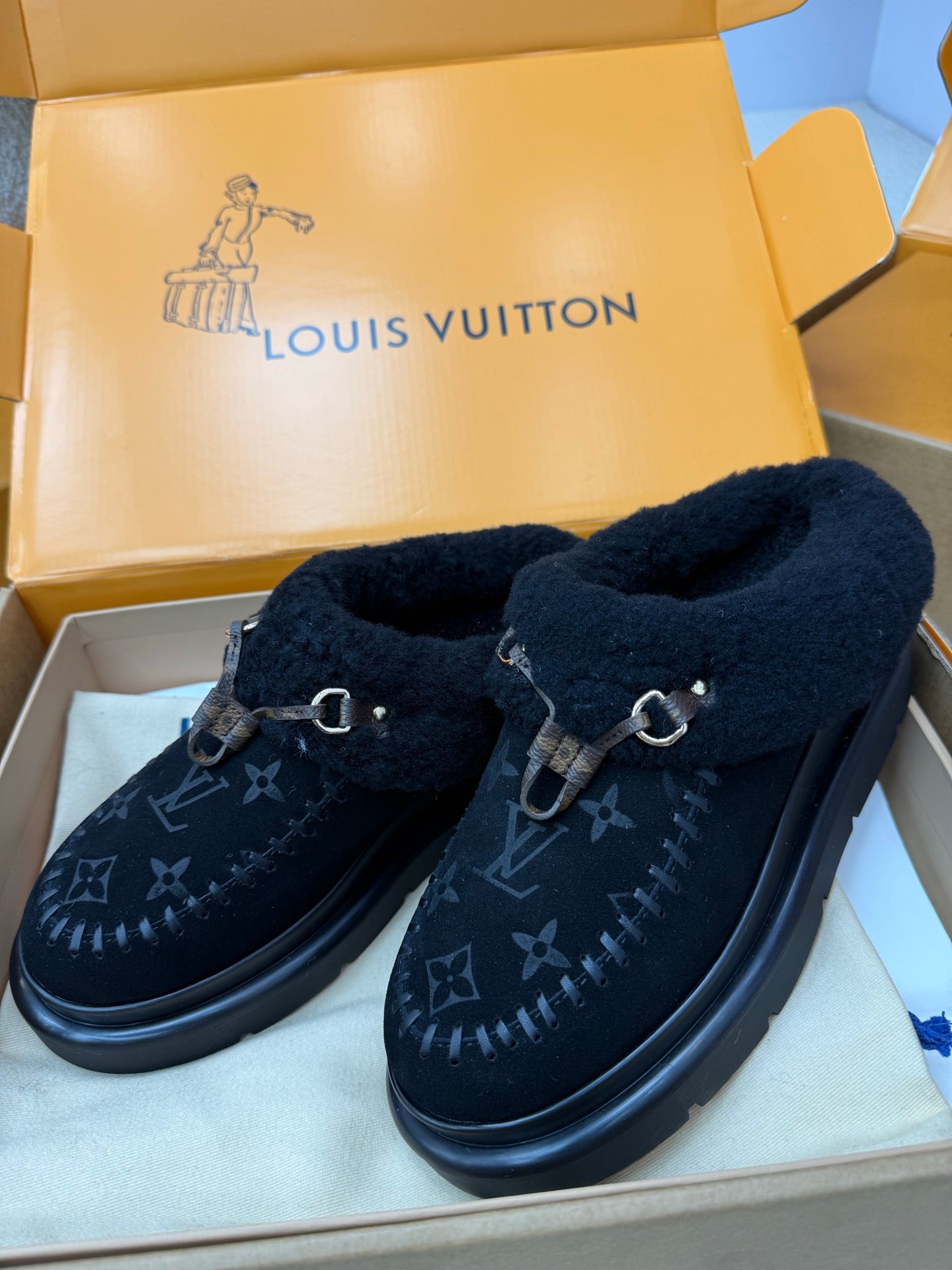 Ladies slip-on shoes with plush cuff, dark monogram print, buckle strap, flat rubber sole