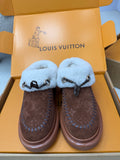 Louis Vuitton shearling mules, brown monogram uppers, light blue fuzzy straps