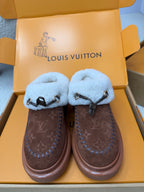 Louis Vuitton shearling mules, brown monogram uppers, light blue fuzzy straps