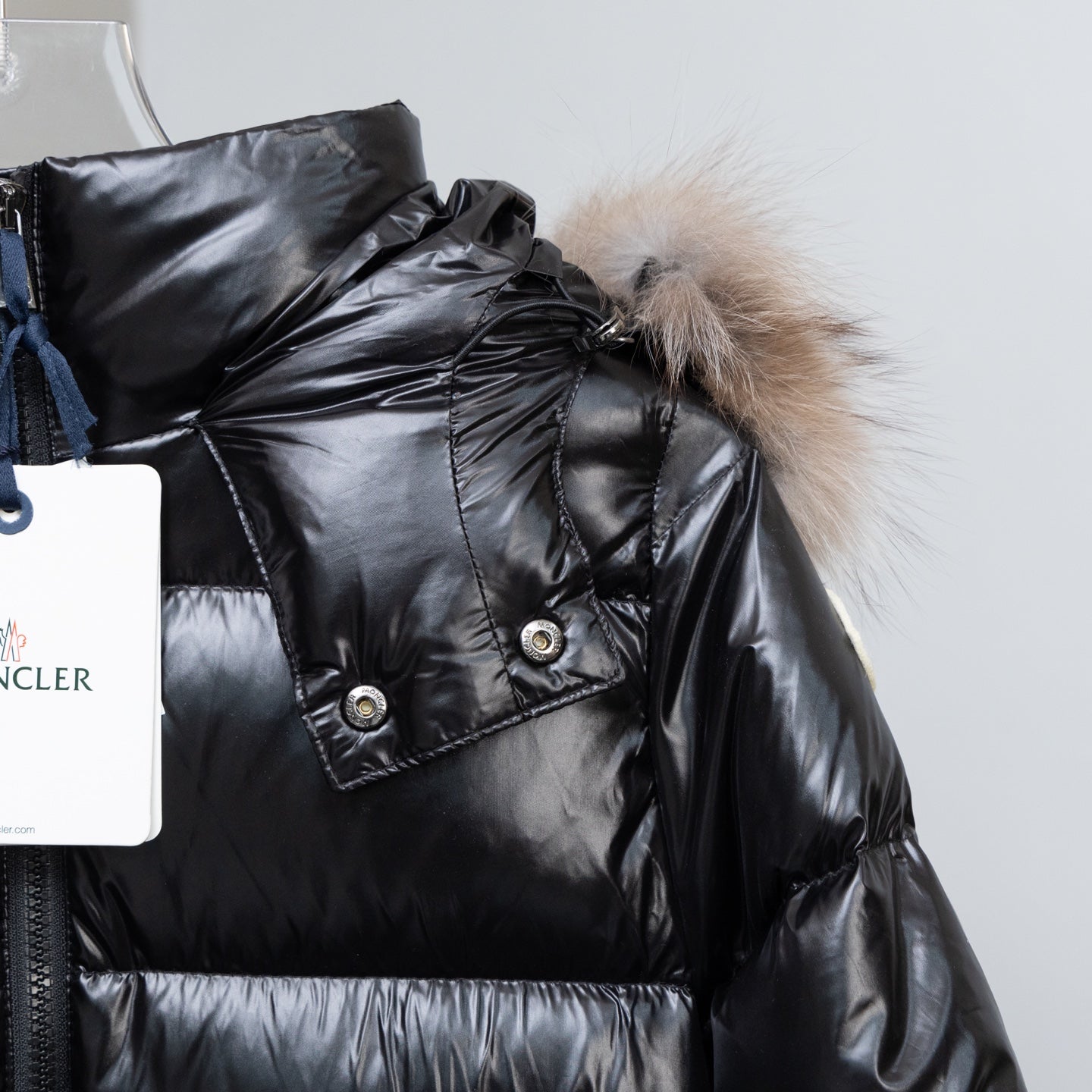Moncler black long puffer coat with fur hood and snap details on shoulder placket