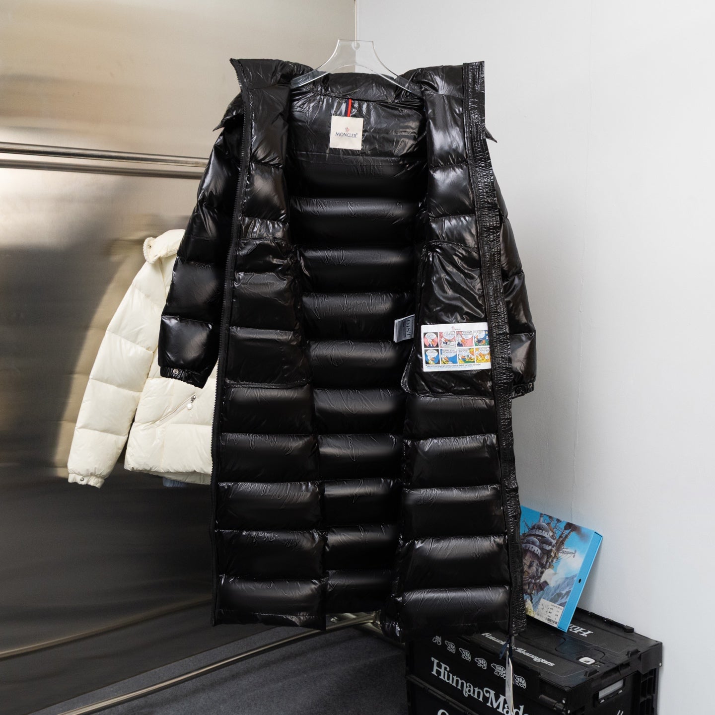 Moncler long black puffer coat on hanger, with fur hood and quilted baffles
