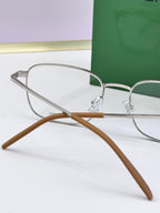 Silver eyeglass frames with clear lenses and light brown temple tips