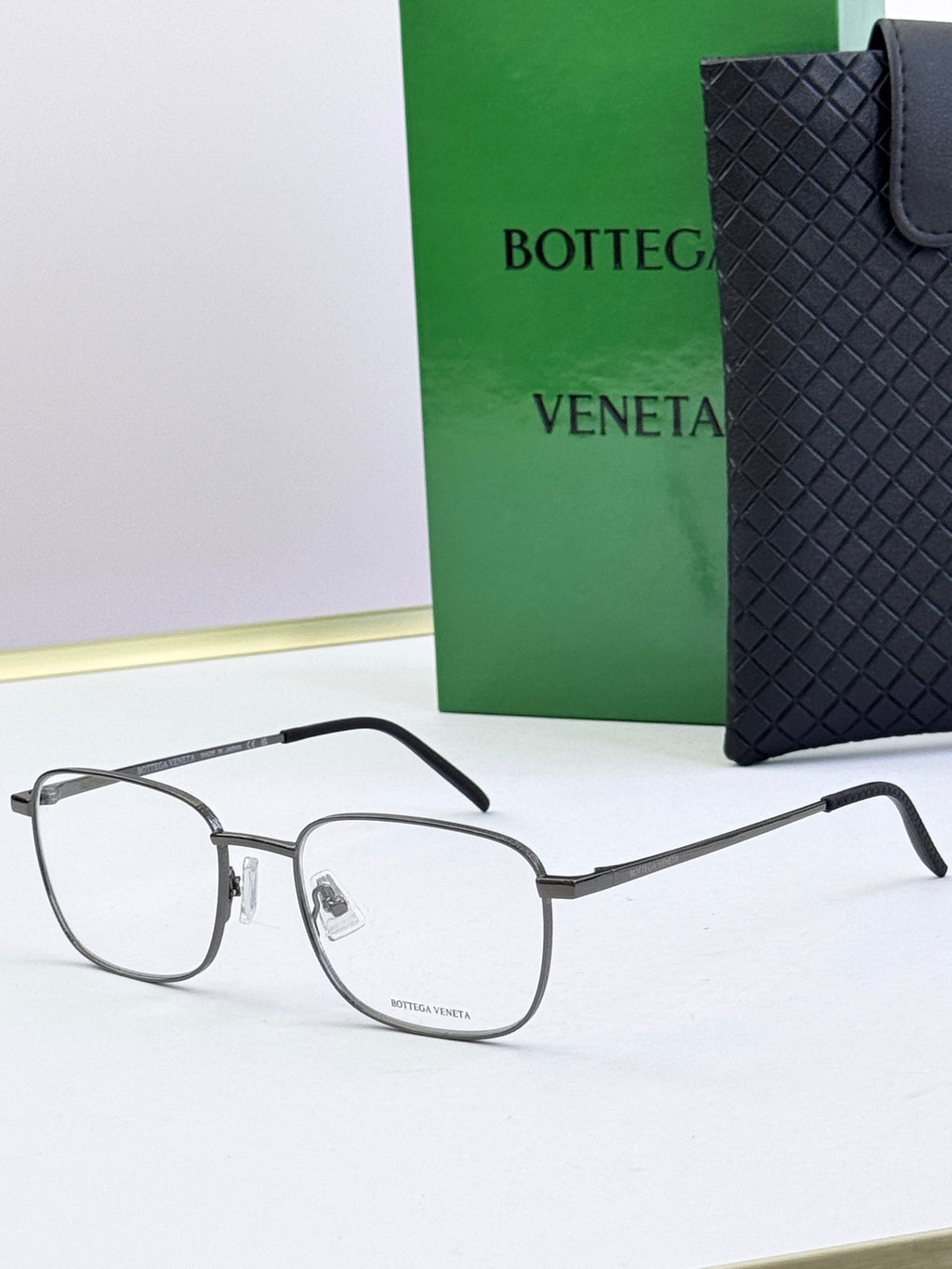 Silver eyeglass frames with clear lenses and dark gray temples