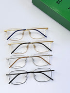 Set of four eyeglass frames with clear lenses in mixed metal and temple colors