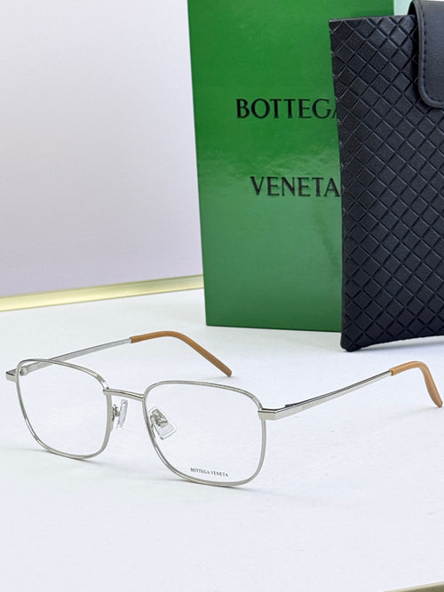 Silver eyeglass frames with clear lenses and light brown temples