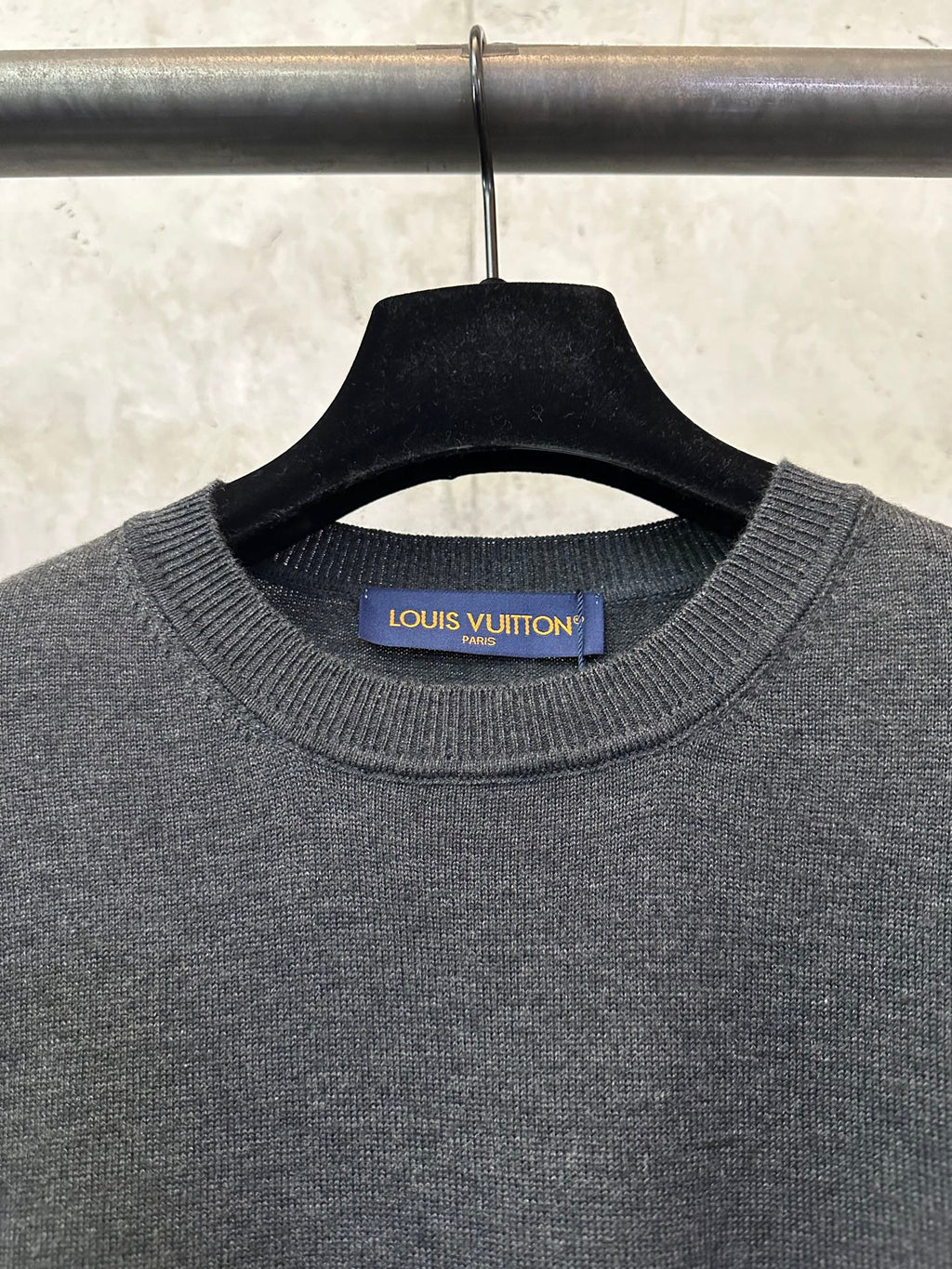 Dark gray knit crewneck sweater with Louis Vuitton label at collar