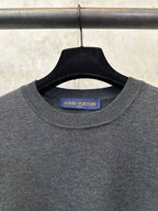 Dark gray knit crewneck sweater with Louis Vuitton label at collar