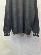 Dark gray sweater hem with ribbed cuffs and logo graphic knit trim