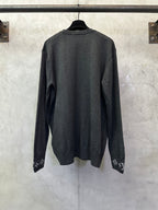 Dark gray long-sleeve crewneck sweater, back view with logo cuff trim