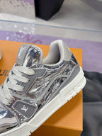 Louis Vuitton women's metallic silver sneaker close-up, gray laces and side logo