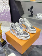 Louis Vuitton women's metallic silver sneakers on tan box, gray laces and logo