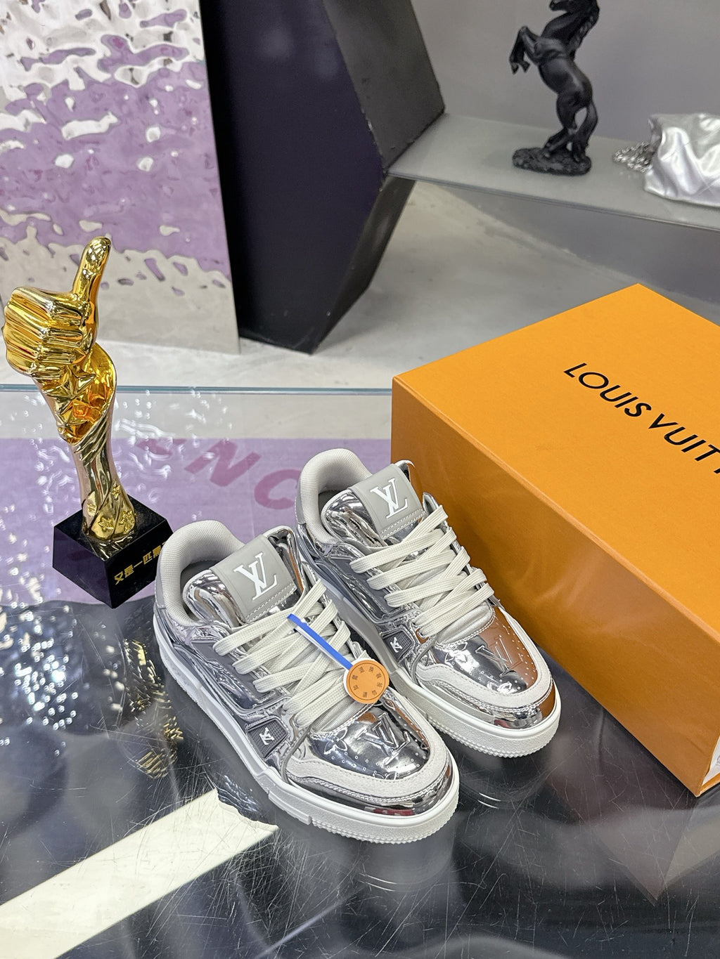 Louis Vuitton women's metallic silver sneakers with gray laces, logo patch detail