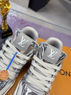 Louis Vuitton women's metallic silver sneakers close-up, gray laces and LV logo patches