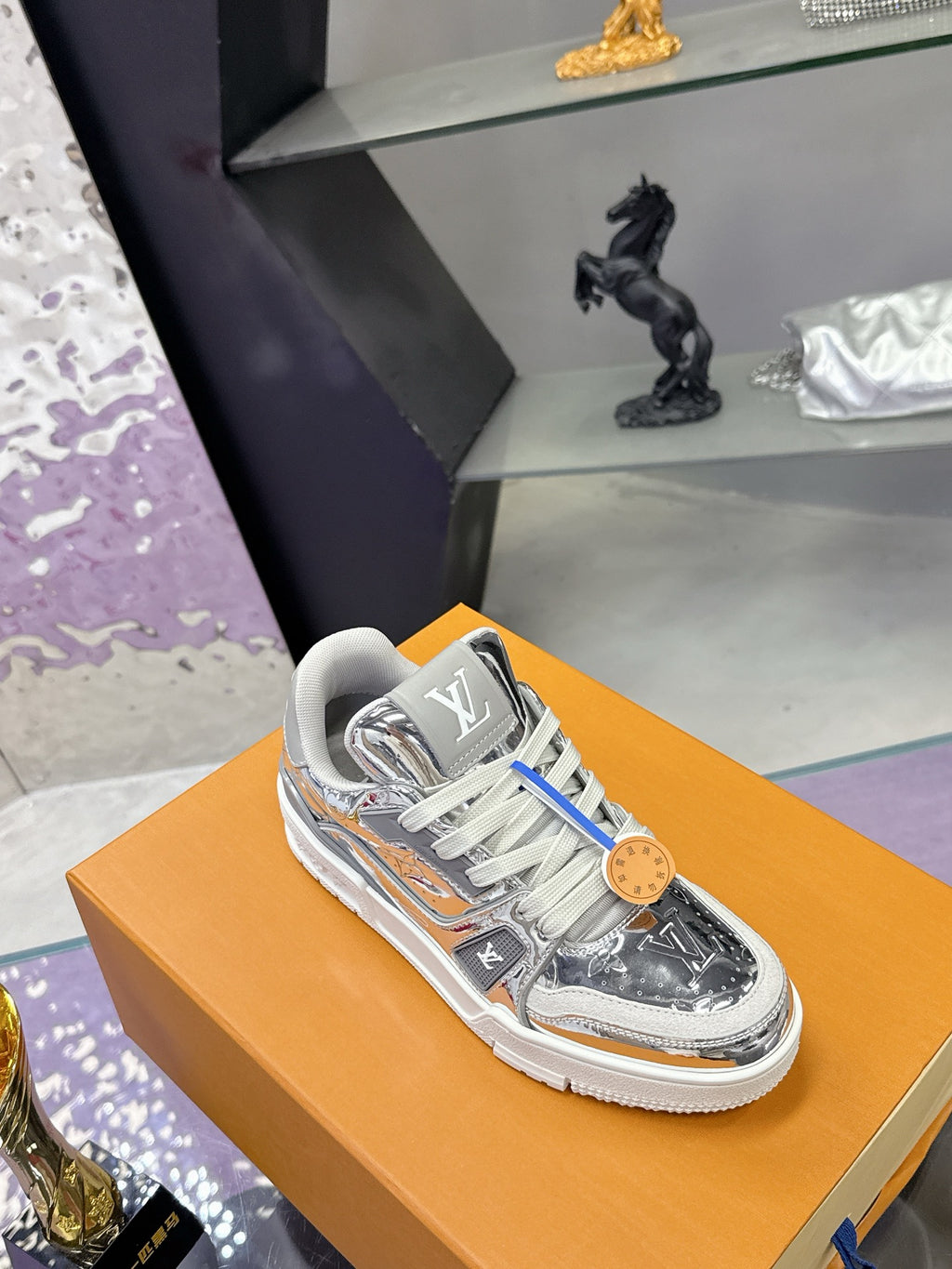 Louis Vuitton women's metallic silver sneaker, side logo and gray lace-up closure