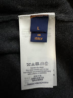 Inside care label on dark gray sweater, size and maintenance instructions