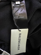 Balenciaga clothing tag and care label on dark fabric