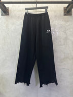 Balenciaga black wide-leg pants with elastic waistband and frayed hem