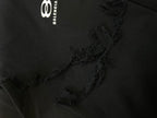 Balenciaga black fabric close-up with frayed seam detail