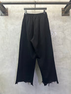 Balenciaga black wide-leg pants, elastic waist, frayed hem, logo detail