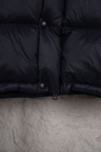 Moncler long puffer jacket front lower section with snap buttons and dark navy fabric