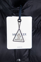 Moncler long puffer jacket with brand swing tag hanging from the hood opening