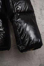 Moncler long puffer jacket hem and pocket area, black with quilted panels