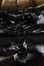 Moncler long puffer jacket close-up of front buttons and quilting, black