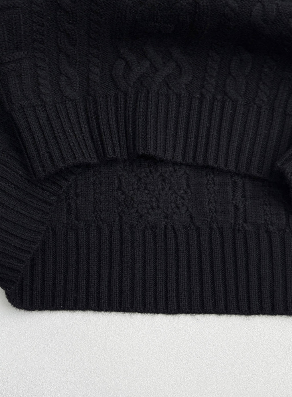 Versace black knit sweater with ribbed hem and textured knit pattern