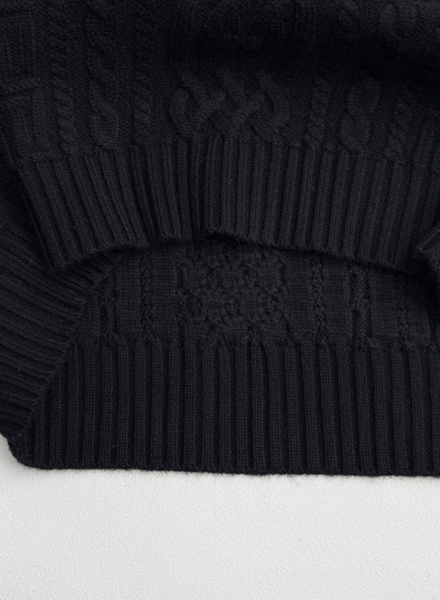 Versace black knit sweater with ribbed hem and textured knit pattern
