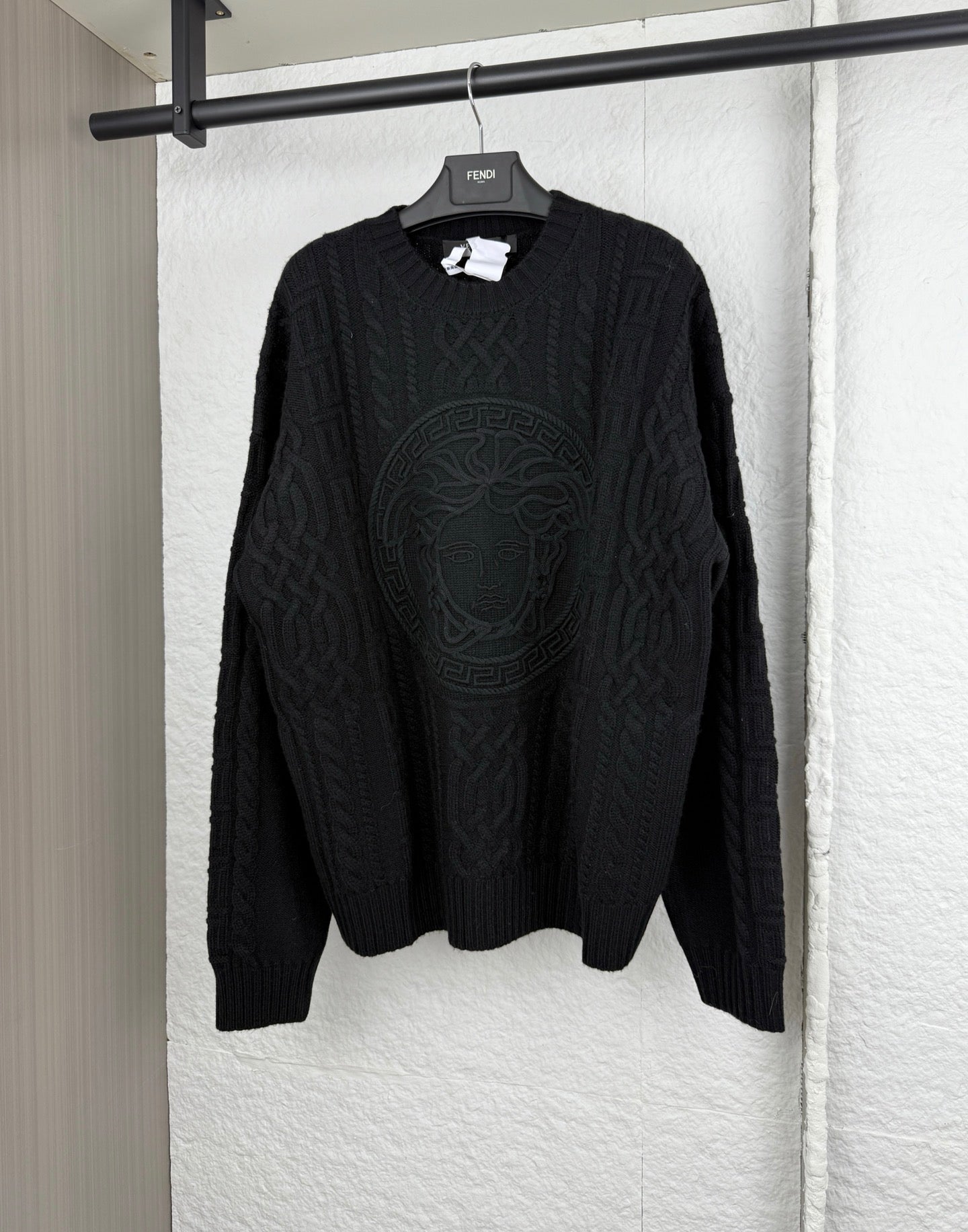 Versace black knit crewneck sweater with raised logo medallion pattern