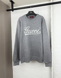 Gucci knit sweater with white script logo on gray crewneck
