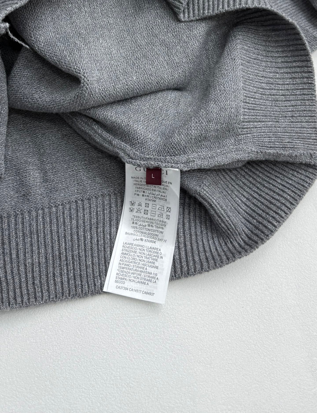 Gucci knit sweater care label inside on gray ribbed collar