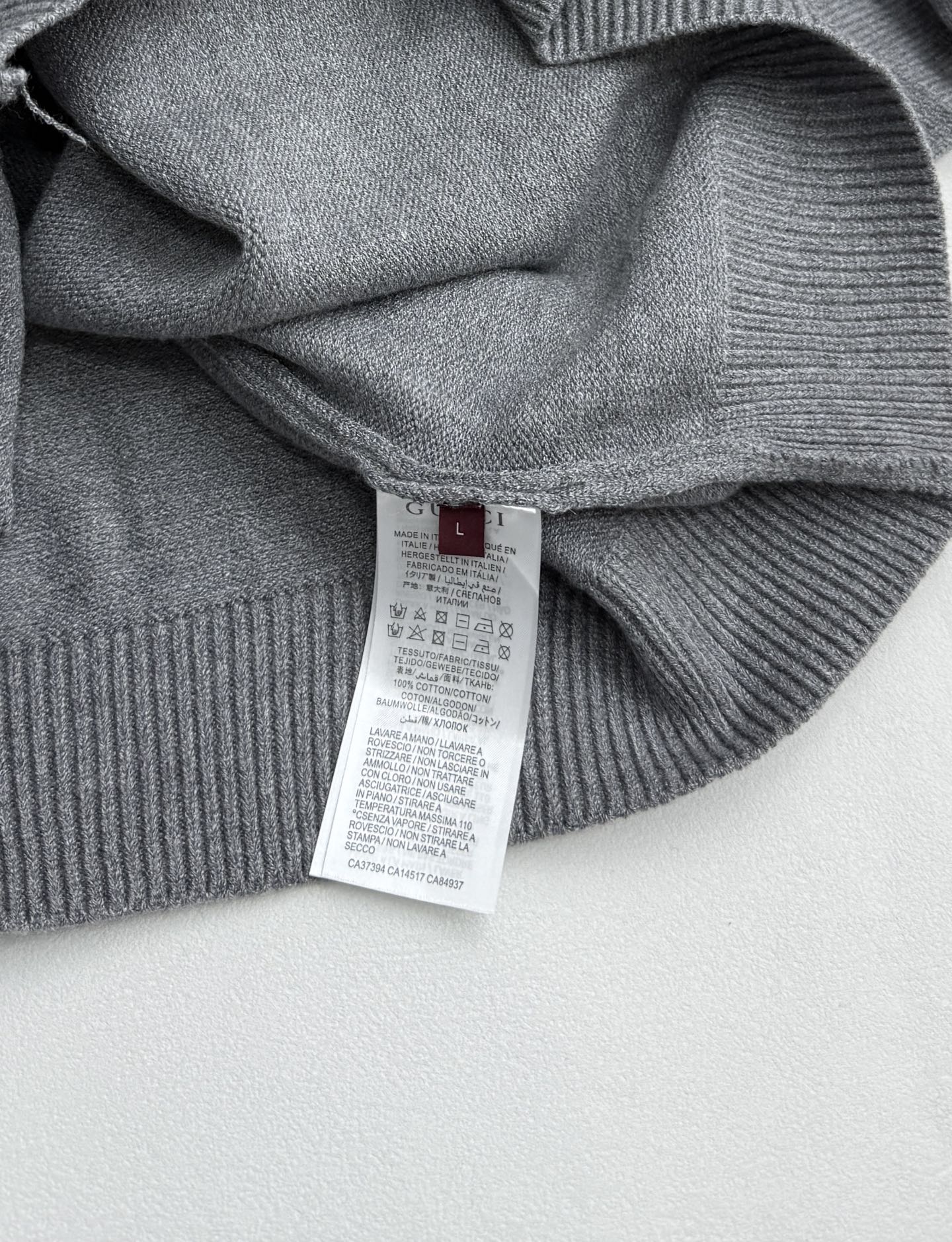 Gucci knit sweater care label inside on gray ribbed collar