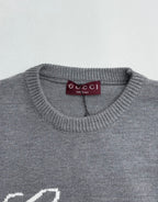 Gucci knit sweater collar with purple Gucci label on gray crewneck