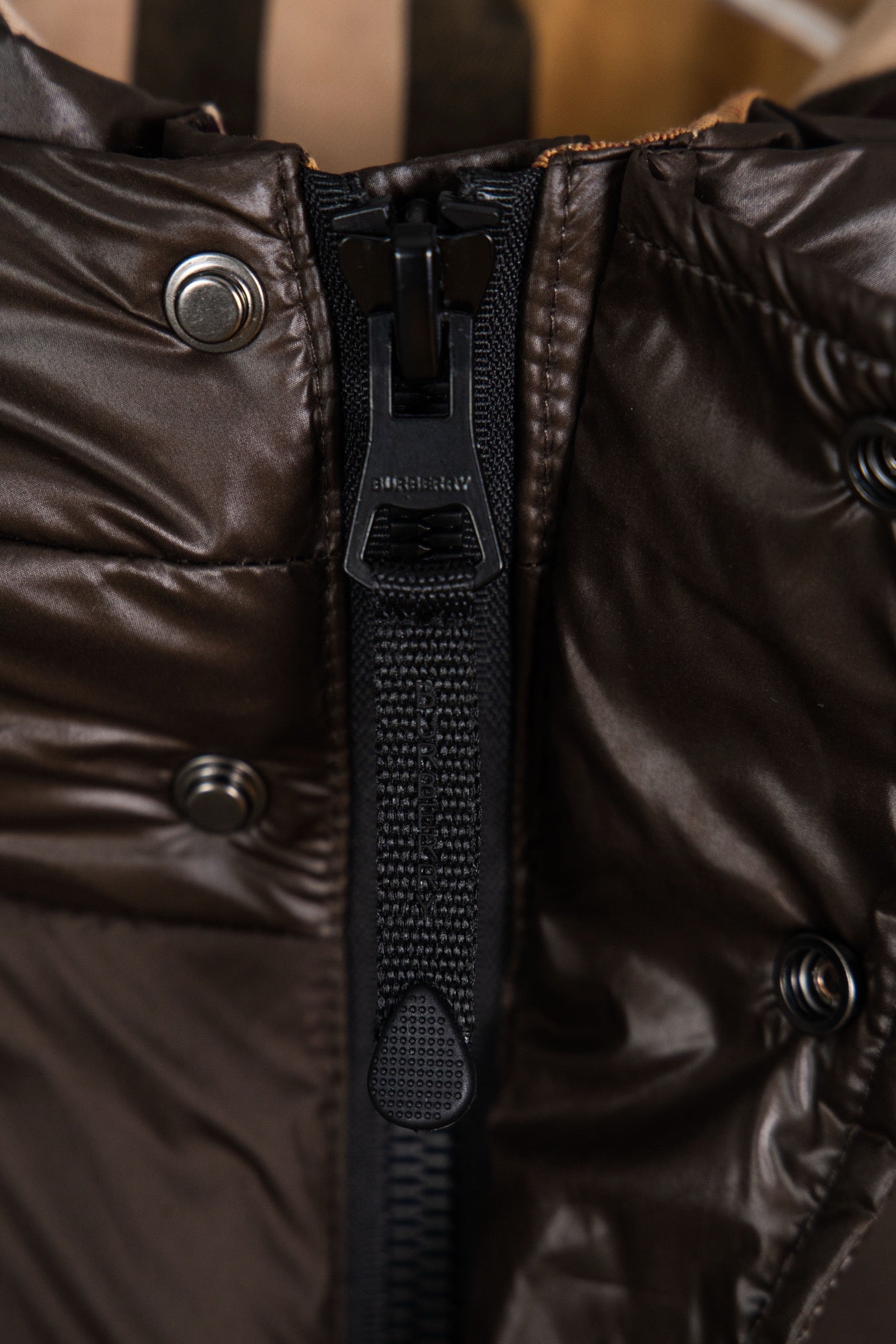Long puffer jacket front zipper with black pull and metal snap details