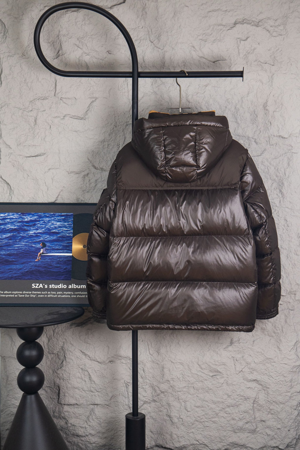 Long puffer jacket in dark brown with stand collar and quilted horizontal panels