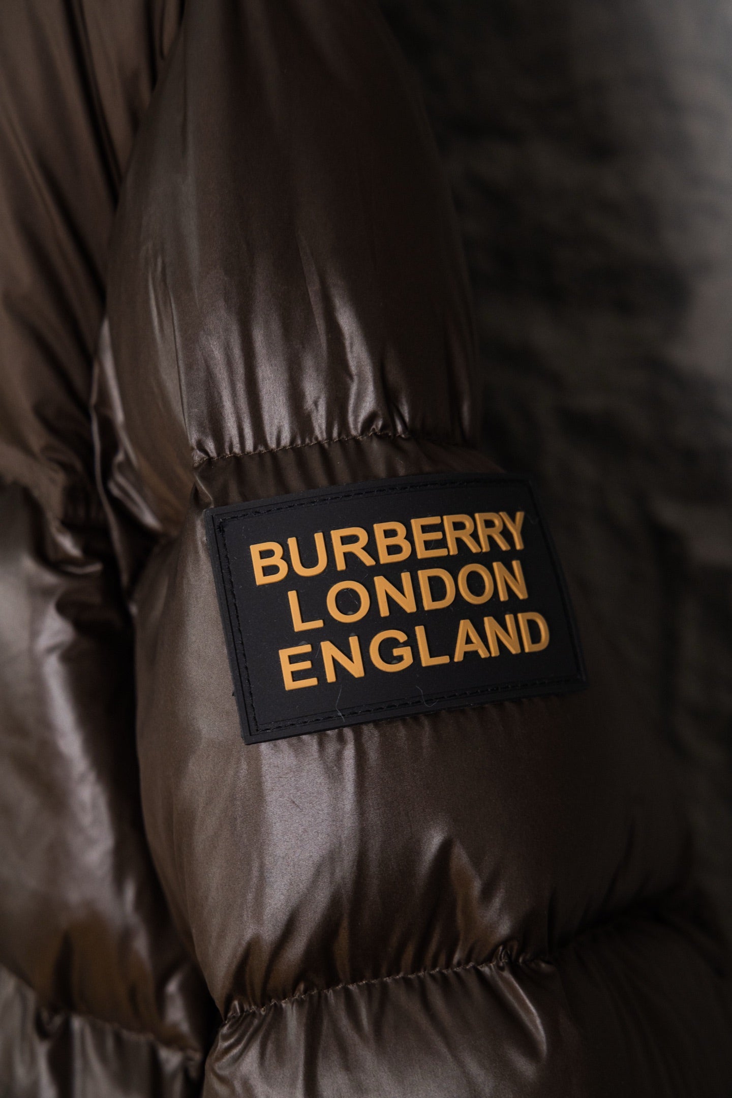 Burberry London England label on dark brown puffer jacket