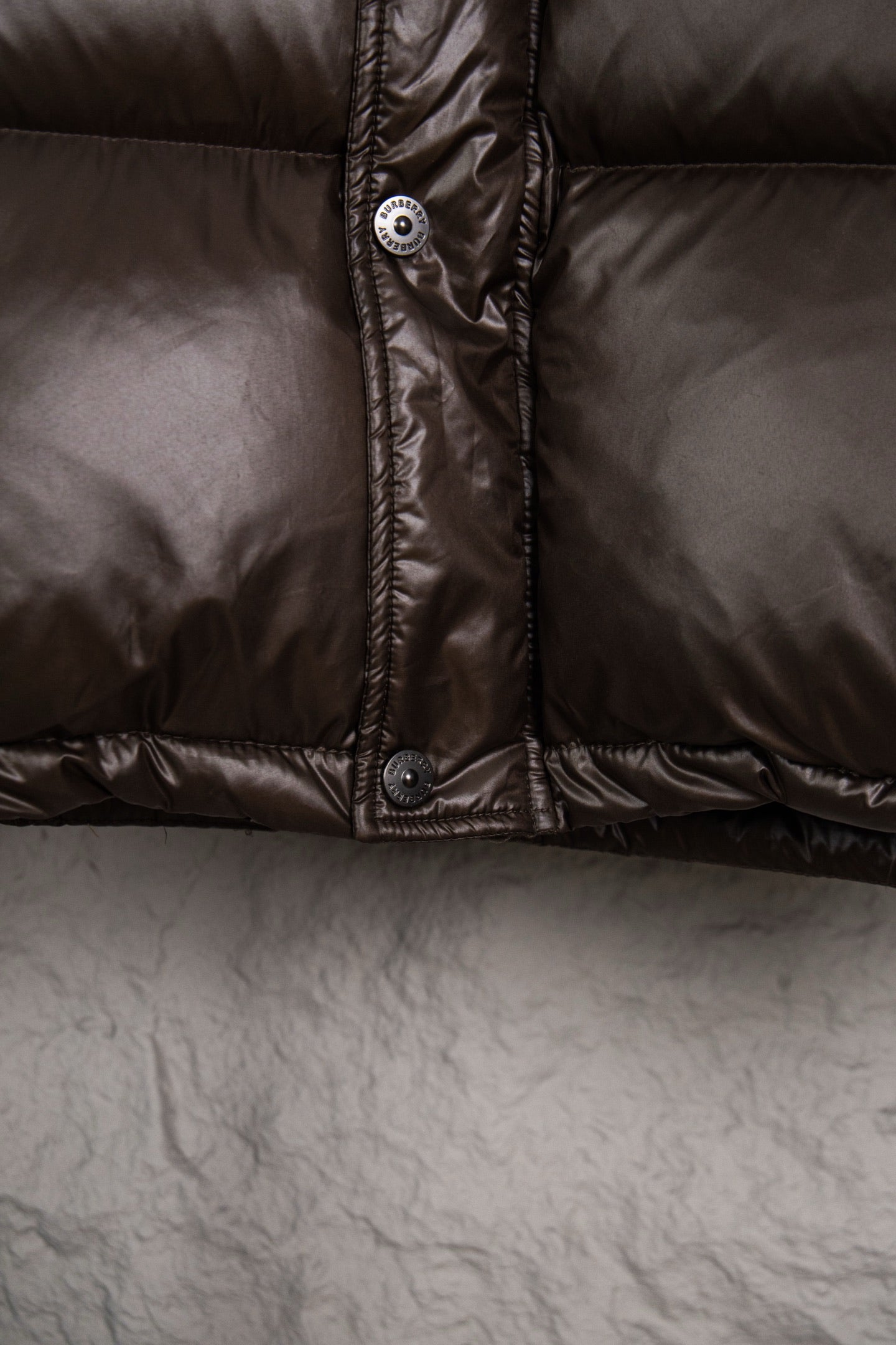 Burberry long padded jacket front placket, dark brown with snap buttons