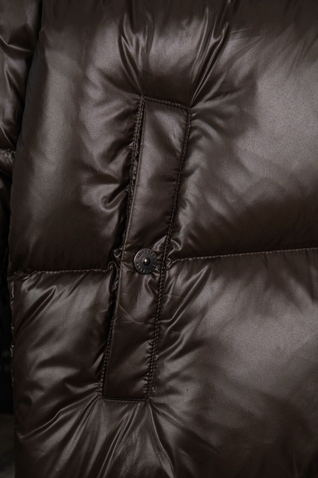 Long puffer jacket with central stitched panel and snap button placket