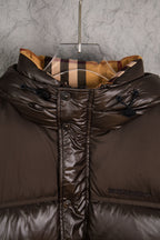 Long puffer jacket with quilted shoulders and dark brown hood
