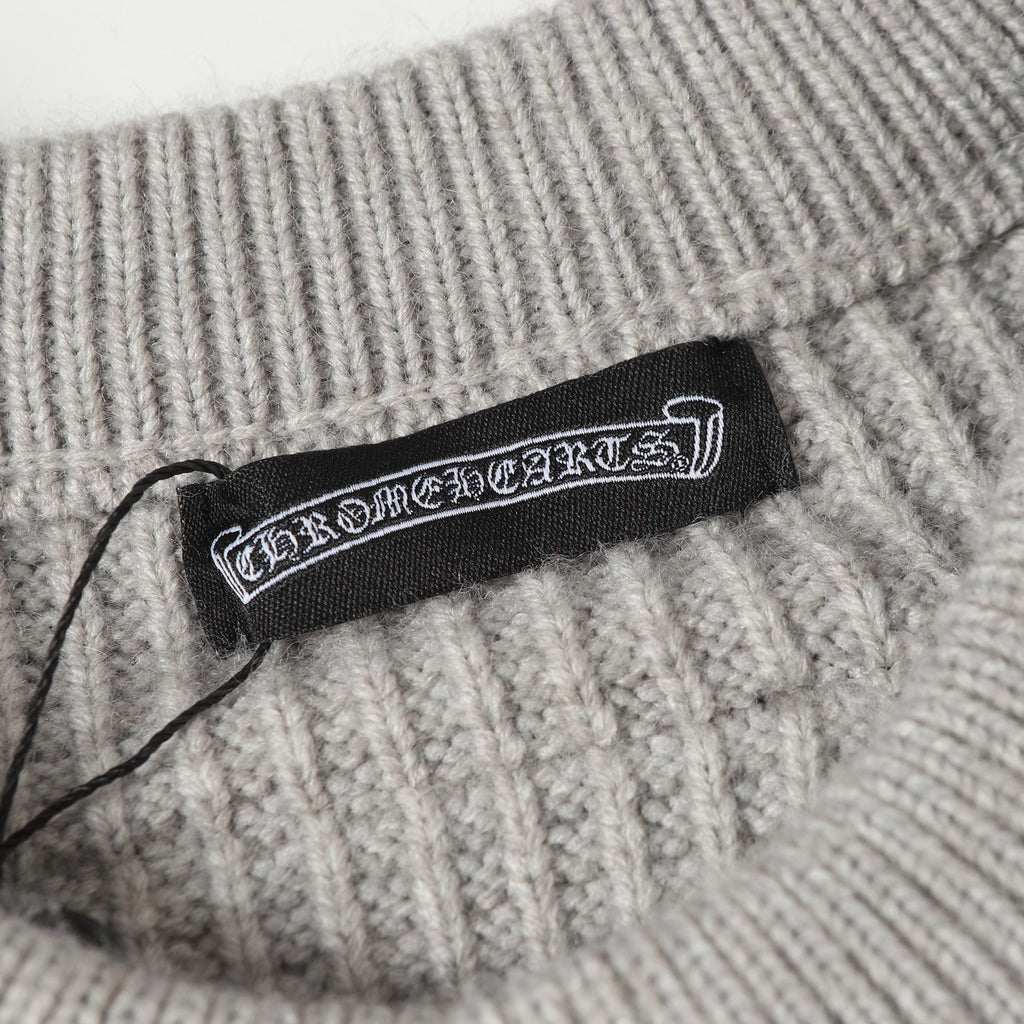 Light gray ribbed knit cardigan with woven brand label at the collar