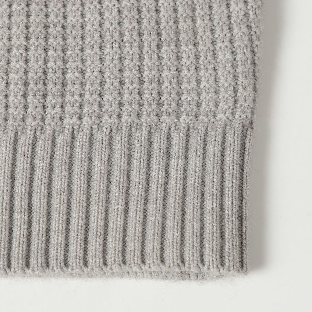 Light gray knit cardigan hem with ribbed texture